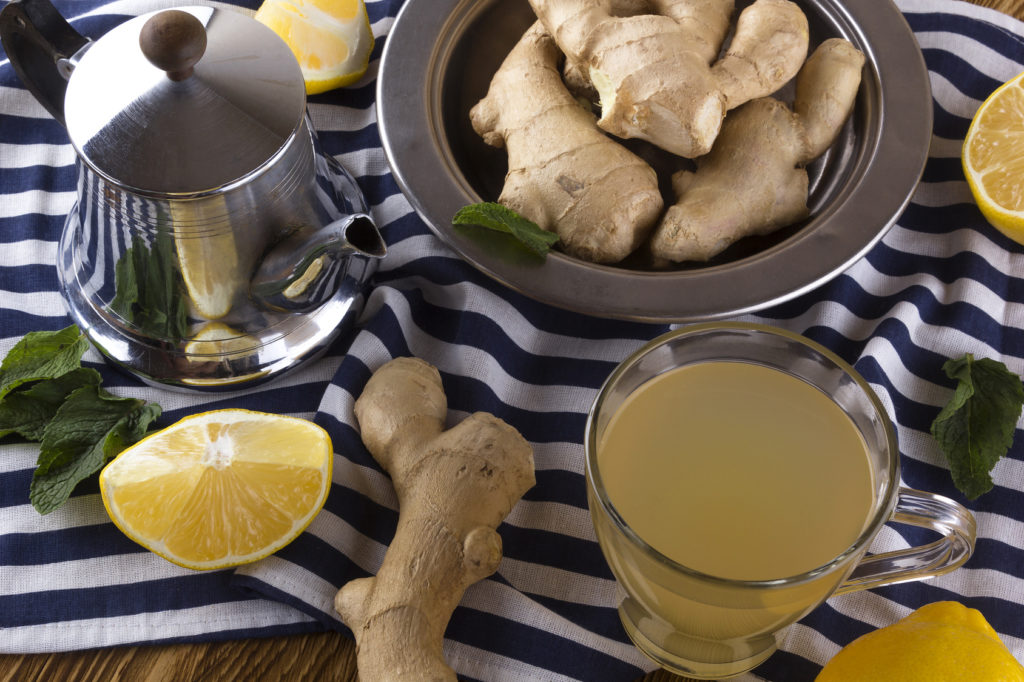ginger tea with mint and lemon on wooden background